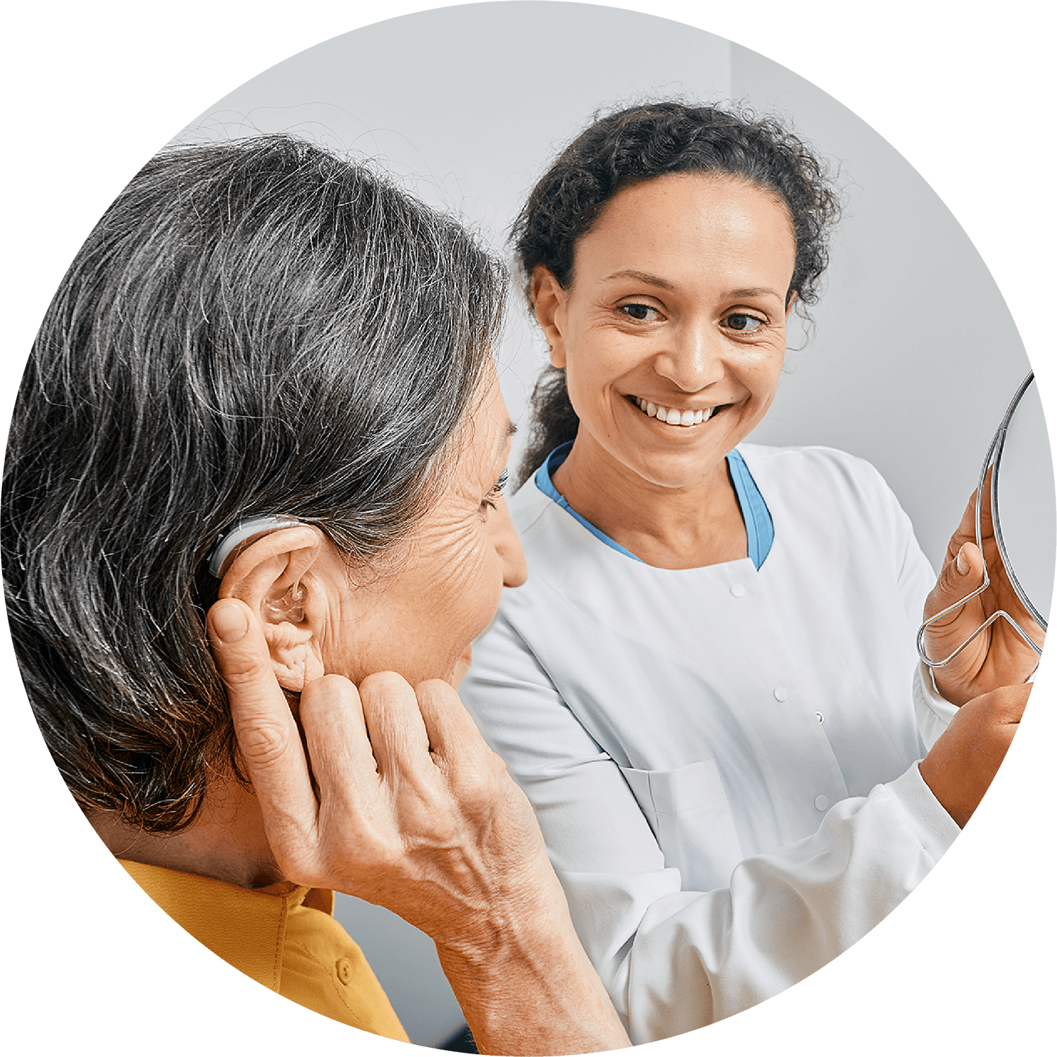 audiologist and older woman with aid